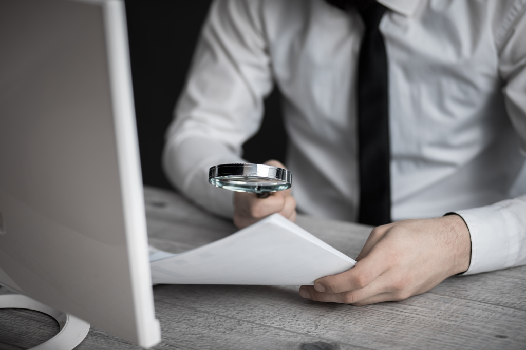 man-hand-magnifier-on-document.jpg