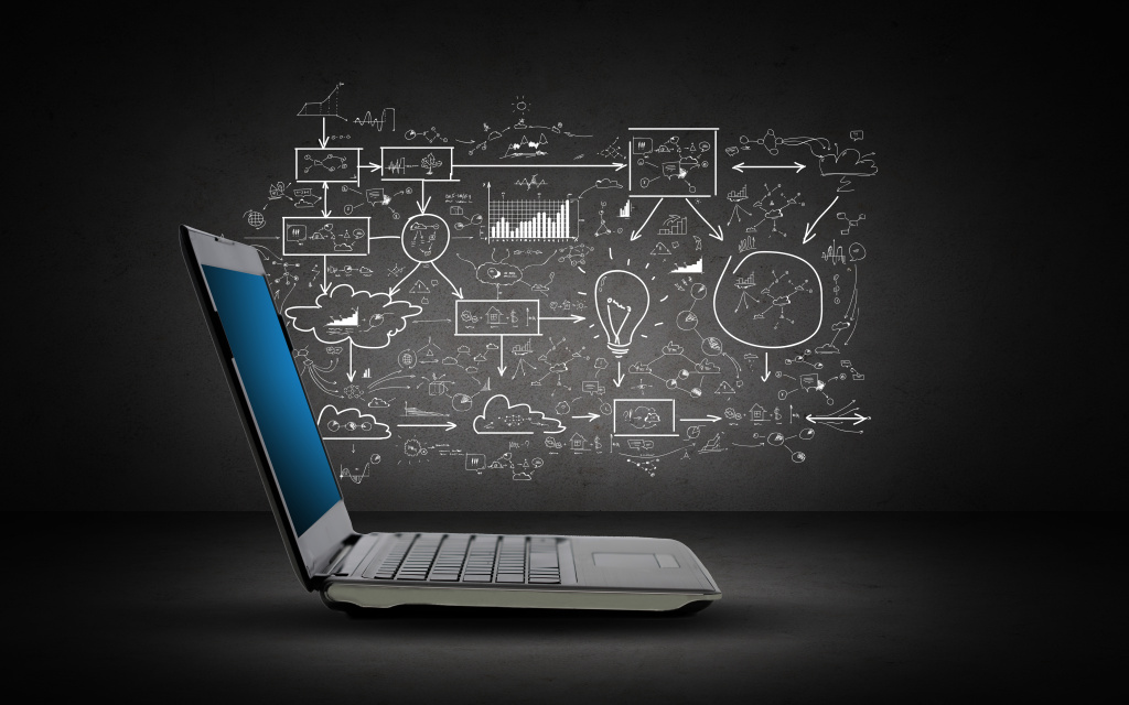 technology-business-planning-and-strategy-concept-open-laptop-computer-with-scheme-and-chart-doodles-over-dark-gray-background.jpg
