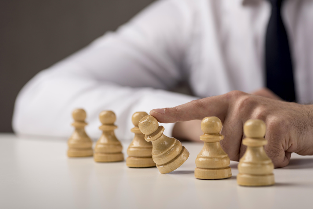 businessman-tumbling-a-pawn.jpg